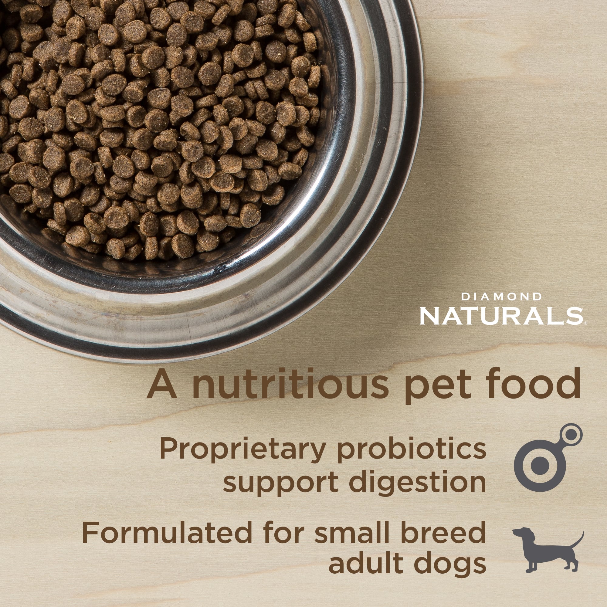 A metal bowl full of Diamond Naturals Small Breed Adult Dog Lamb & Rice Formula kibble.