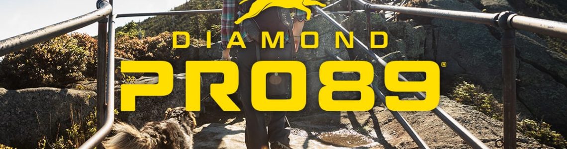 Woman hiking up a mountain with her dog | Diamond Pro89®